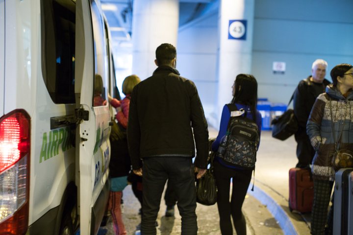 Travellers boarding a shuttle at the airport